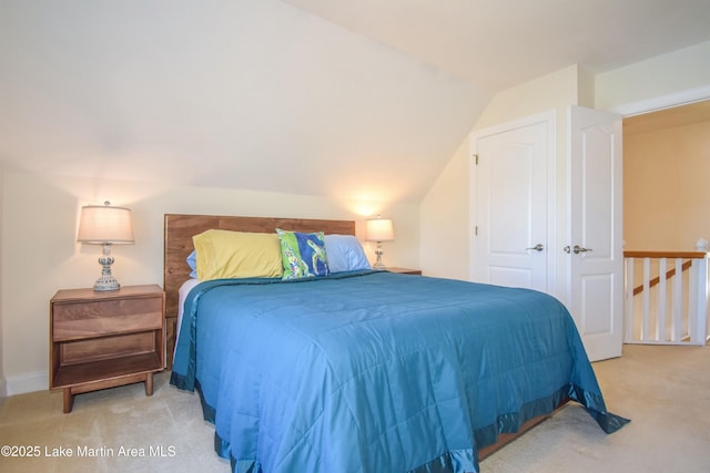 bedroom featuring carpet floors and vaulted ceiling