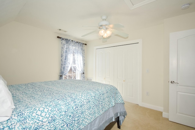 bedroom featuring baseboards, visible vents, ceiling fan, a closet, and light carpet