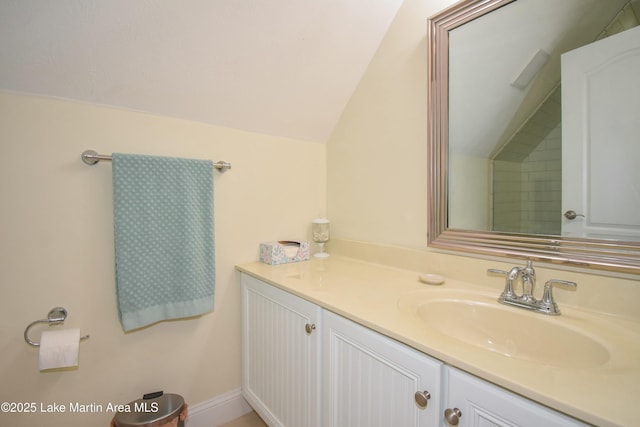 bathroom with vanity and lofted ceiling