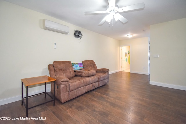 living room featuring a ceiling fan, an AC wall unit, wood finished floors, and baseboards