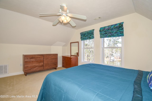 carpeted bedroom featuring lofted ceiling, baseboards, visible vents, and ceiling fan