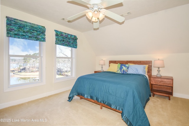 bedroom featuring visible vents, carpet floors, baseboards, and vaulted ceiling