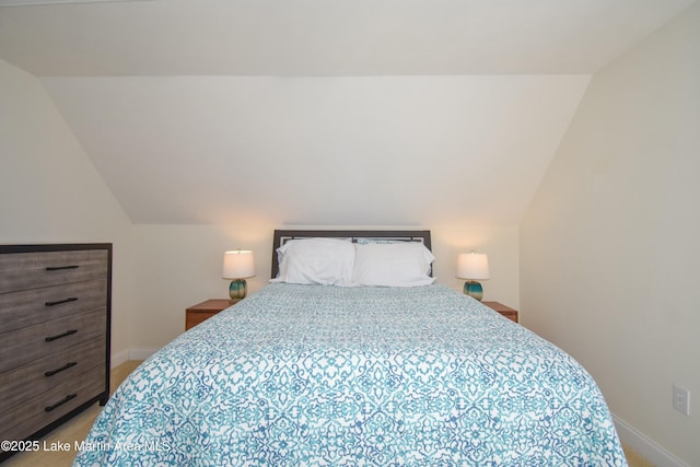 bedroom featuring vaulted ceiling, carpet, and baseboards