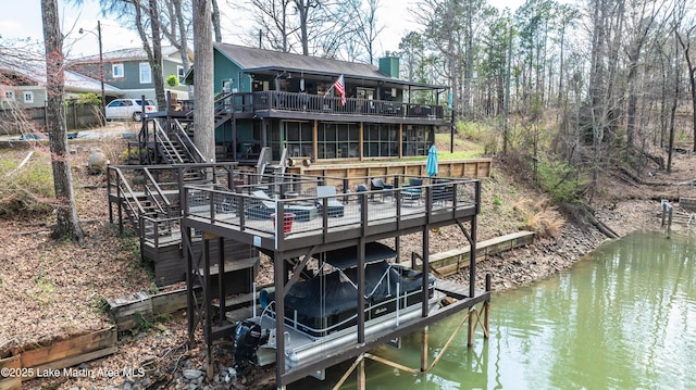 dock area featuring stairway and a deck with water view