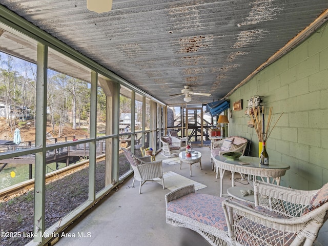 unfurnished sunroom featuring a ceiling fan