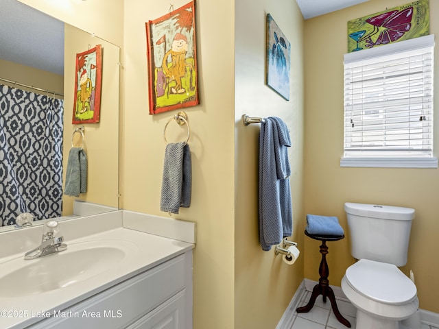 bathroom with vanity, a shower with shower curtain, baseboards, tile patterned floors, and toilet