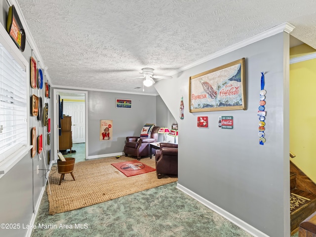 interior space with ceiling fan, carpet floors, a textured ceiling, and ornamental molding