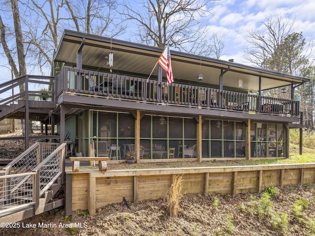 back of house featuring stairway and a sunroom