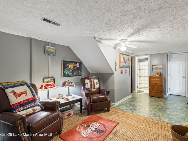 living area with baseboards, a ceiling fan, visible vents, and a textured ceiling