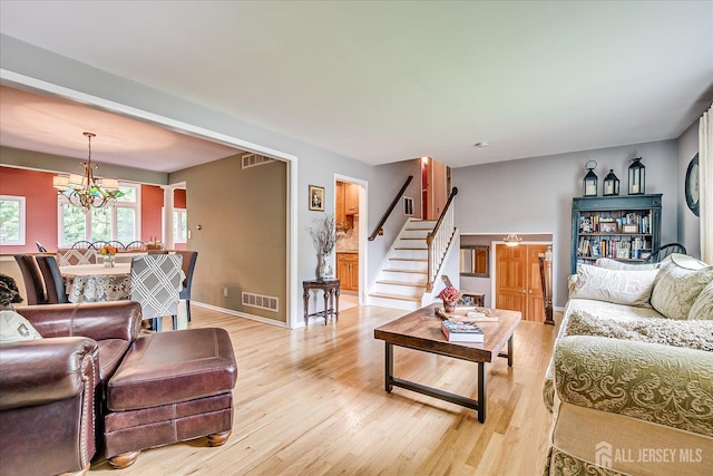 6 Zaydee Dr, Edison, NJ 08837 - living room featuring light wood-type flooring, stairway, and a chandelier