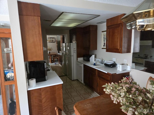 146 Old Nassau Rd, Monroe, NJ 08831 - kitchen with freestanding refrigerator, a sink, light floors, dishwashing machine, and light countertops