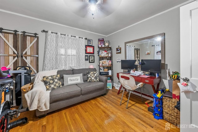 living area featuring a ceiling fan, wood finished floors, an office area, and ornamental molding