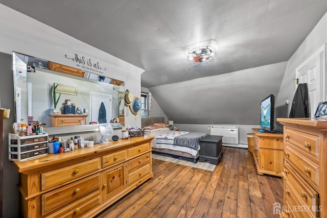 bedroom featuring hardwood / wood-style flooring and vaulted ceiling