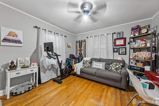 living room featuring ceiling fan, wood finished floors, and ornamental molding