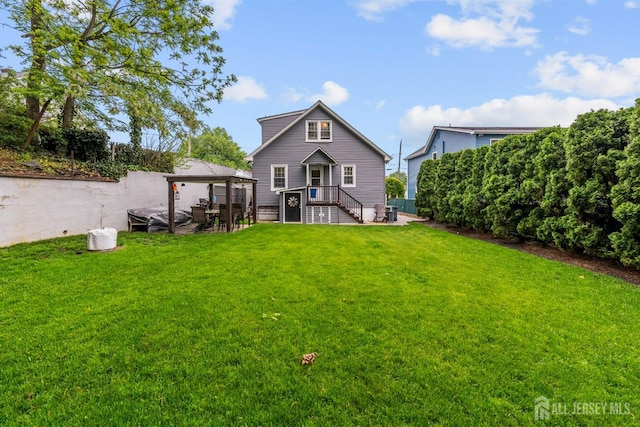 back of property with a gazebo and a jacuzzi