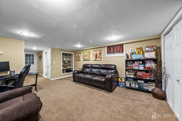 carpeted living area with a desk, baseboards, recessed lighting, and built in features