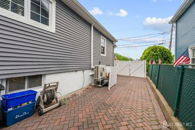view of patio with a gate, ac unit, and a fenced backyard