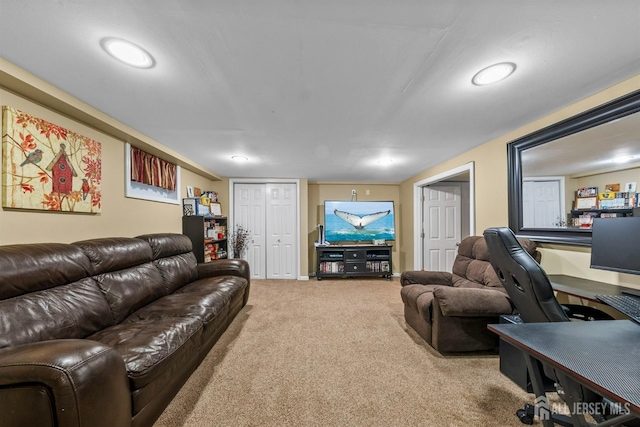 carpeted living area with recessed lighting