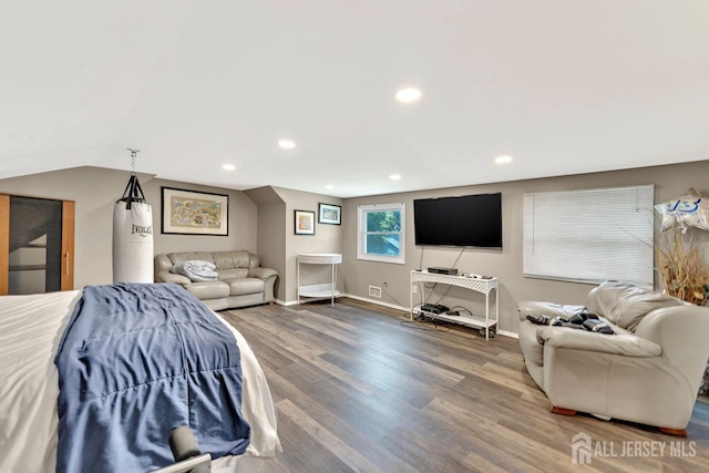 bedroom featuring hardwood / wood-style flooring and lofted ceiling