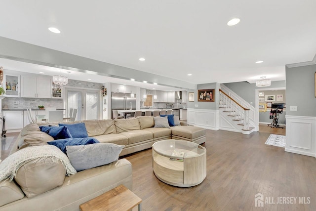 living room with wood-type flooring and a chandelier