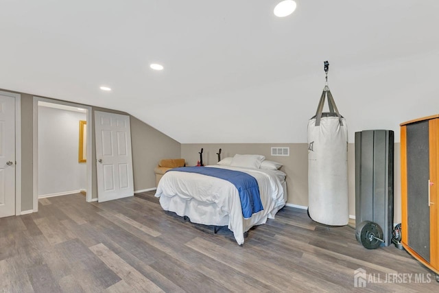 bedroom with hardwood / wood-style flooring and vaulted ceiling