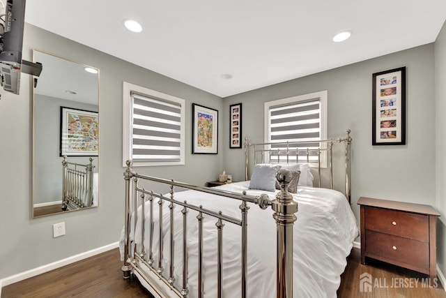 bedroom with dark wood-type flooring