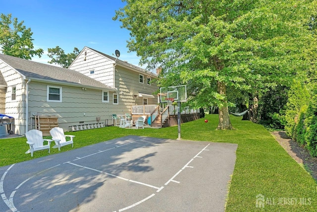 view of basketball court featuring a yard