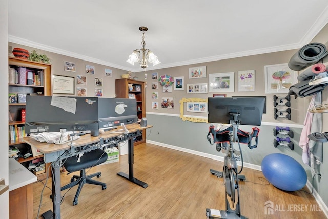 office area with hardwood / wood-style floors, crown molding, and a chandelier