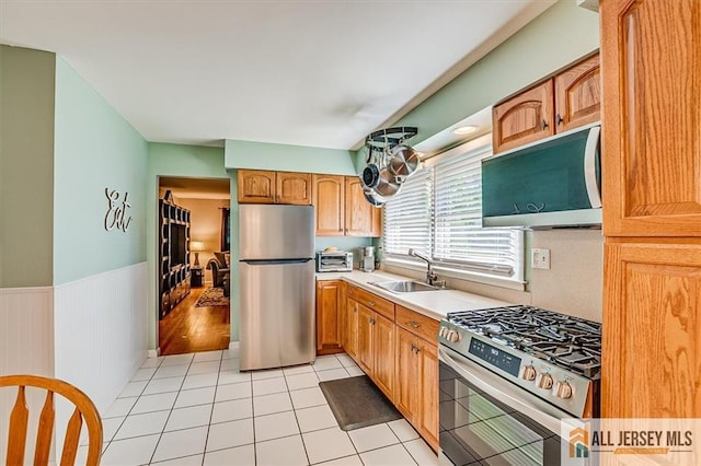 20 Melville Rd, Edison, NJ 08817 - kitchen featuring appliances with stainless steel finishes, light countertops, wainscoting, and light tile patterned floors