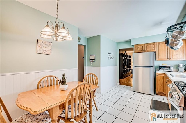 20 Melville Rd, Edison, NJ 08817 - dining space with wainscoting, a chandelier, and light tile patterned floors