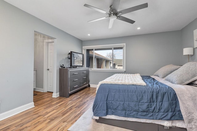 bedroom with dark hardwood / wood-style flooring and ceiling fan