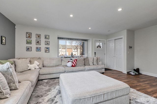 living room featuring baseboards, dark wood-style flooring, and recessed lighting