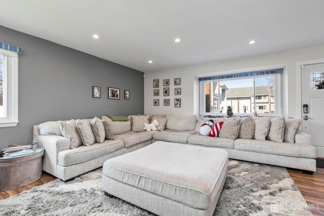 living room with dark wood finished floors and recessed lighting