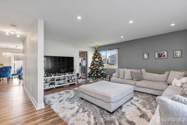 living room with hardwood / wood-style floors and a chandelier