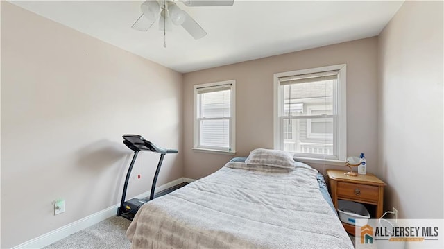 carpeted bedroom featuring a ceiling fan and baseboards