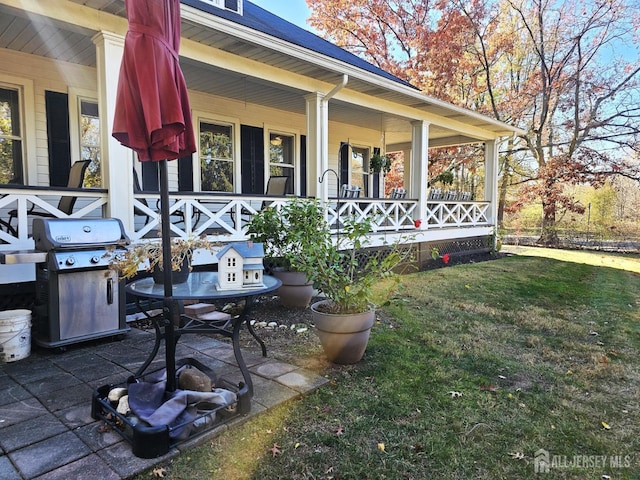 view of patio with area for grilling and covered porch