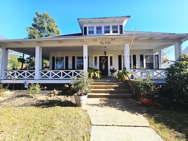 view of front facade with covered porch and a front lawn