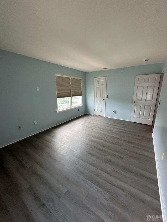 unfurnished room featuring hardwood / wood-style flooring