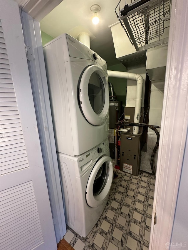 laundry area with stacked washer / dryer and gas water heater