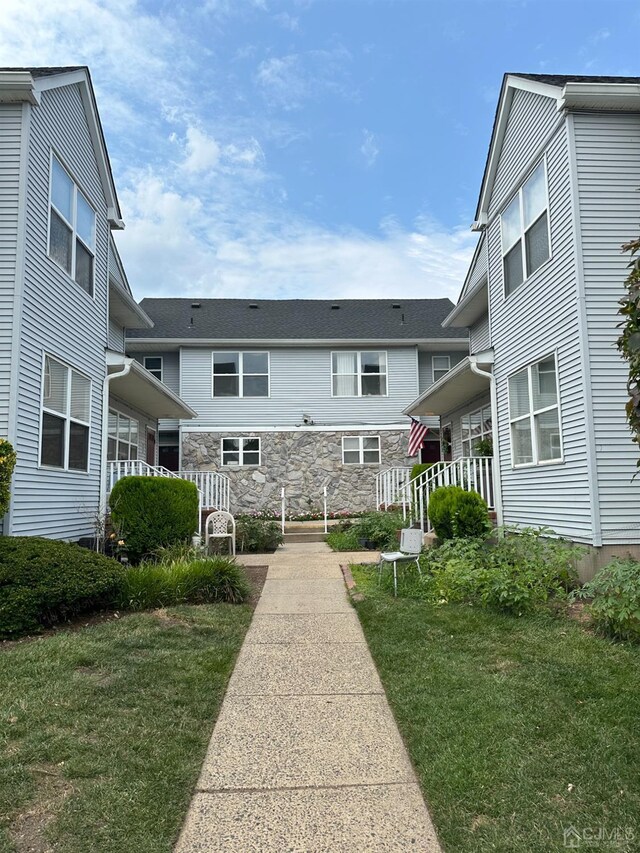 view of home's community featuring a lawn