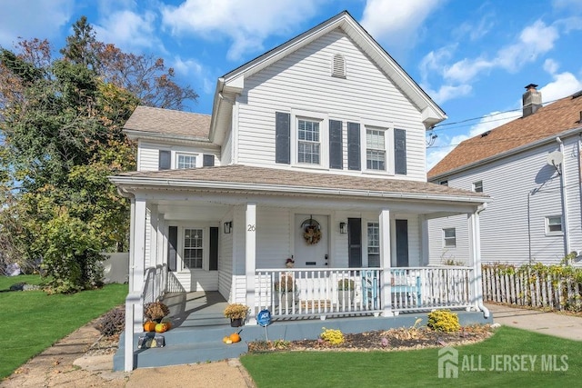 view of front of home with covered porch and a front yard