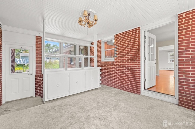 unfurnished sunroom featuring an inviting chandelier and baseboard heating