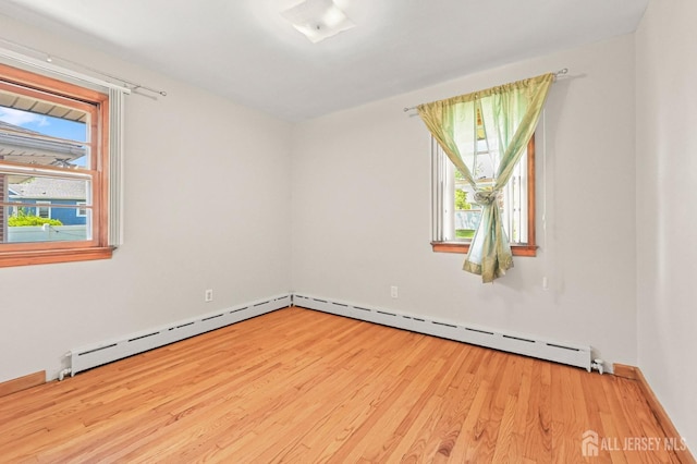 spare room featuring wood finished floors and a wealth of natural light
