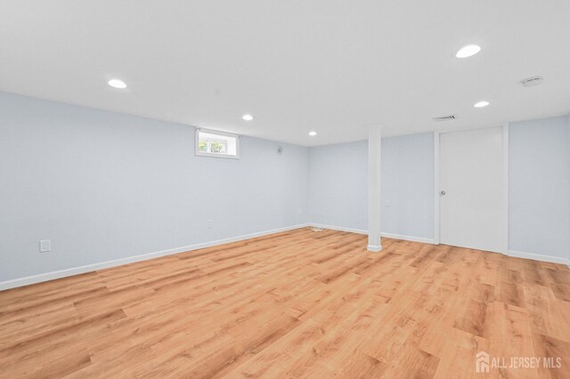 basement with recessed lighting, baseboards, visible vents, and light wood-style floors