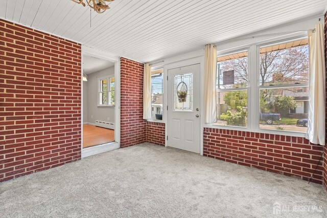 exterior space with a baseboard radiator, carpet, brick wall, and wooden ceiling