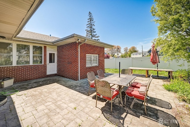 view of patio featuring a fenced backyard and outdoor dining area