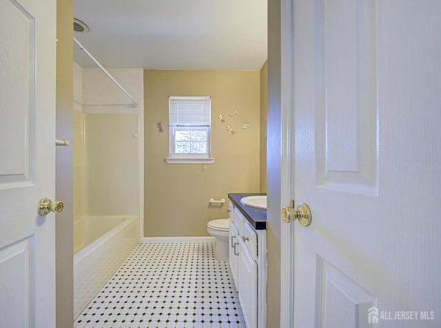 full bathroom featuring vanity, baseboards, bathtub / shower combination, and toilet