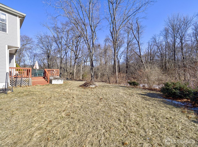 view of grassy yard featuring a deck