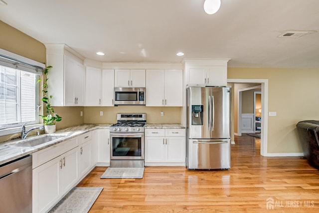 169 Metuchen Ave, Woodbridge Proper, NJ 07095 - kitchen featuring stainless steel appliances, white cabinets, light wood-style floors, and recessed lighting