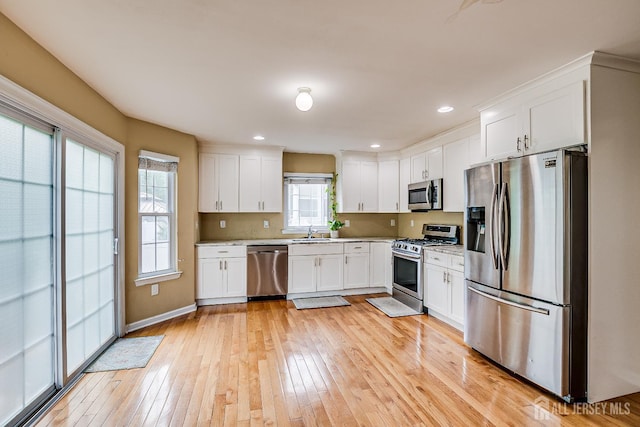 169 Metuchen Ave, Woodbridge Proper, NJ 07095 - kitchen featuring stainless steel appliances, white cabinetry, light wood finished floors, and recessed lighting